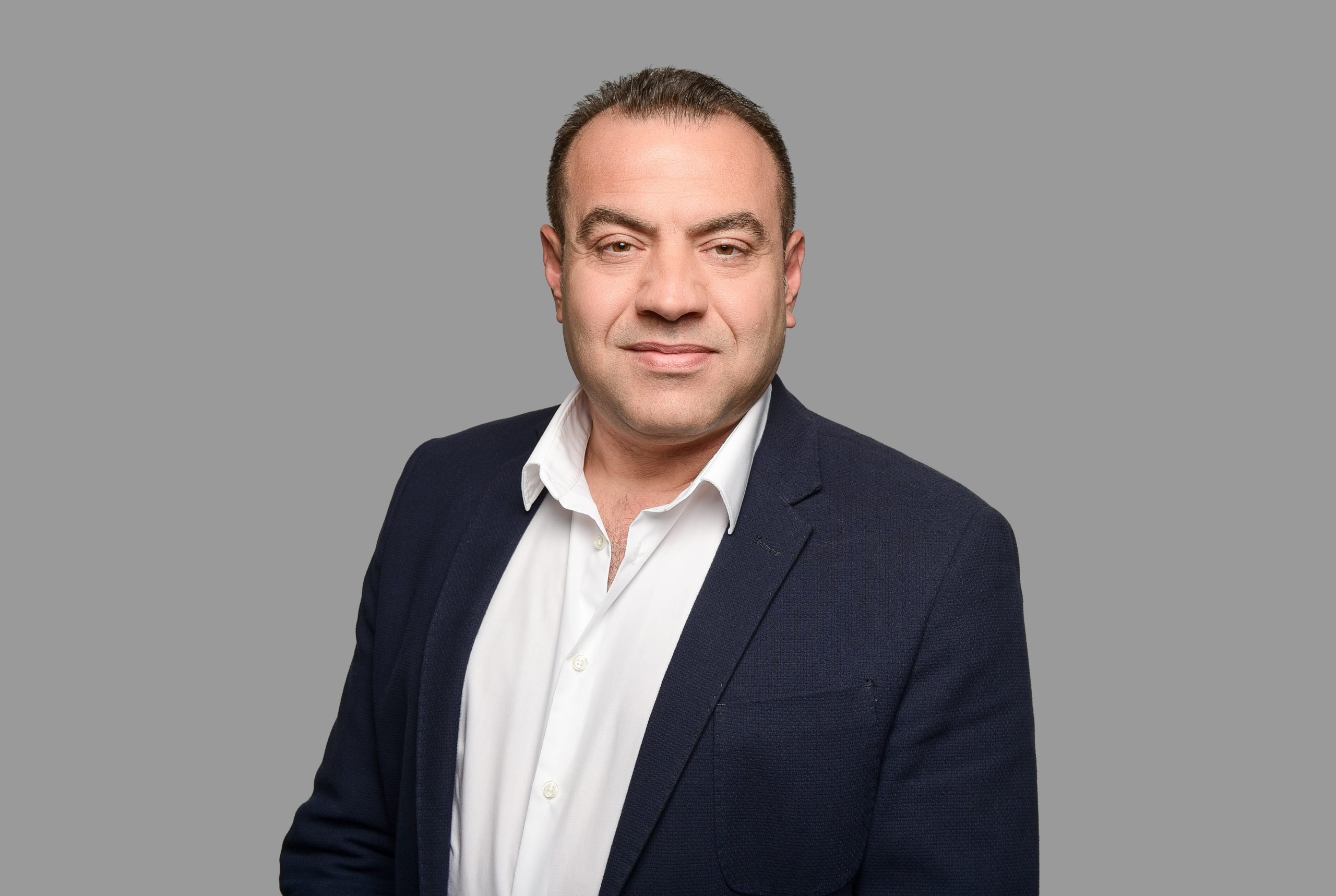 Taskin Can Portrait with grey background of Taskin Can